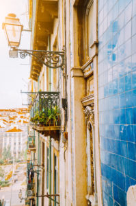 Traditional facade front of portuguese buildings with balconys and lamps. Old charming street in Lisbon, Lisboa, Lissabon, Portugal, Europe Traditional facade front of portuguese buildings with balconys and lamps. Old charming street in Lisbon, Lisboa, Lissabon, Portugal, Europe